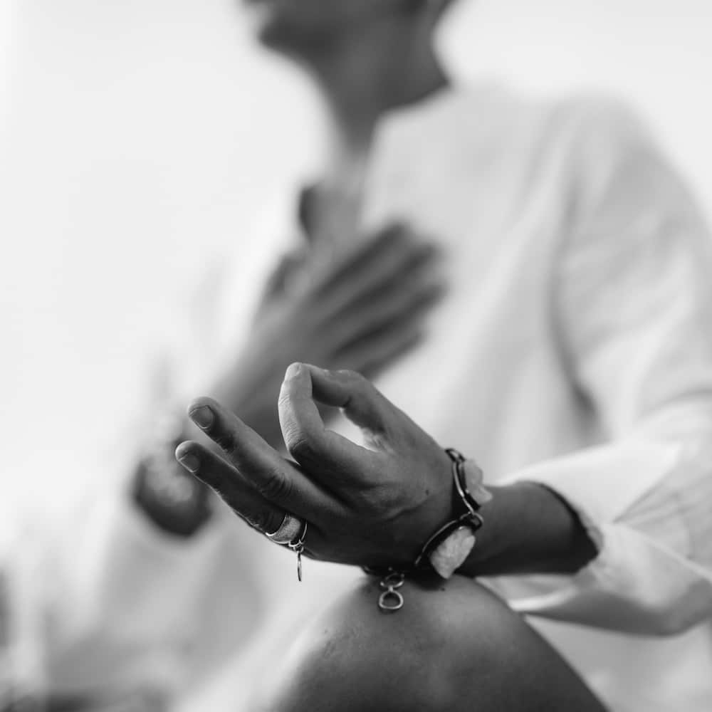 Close up of hand posed in meditation.