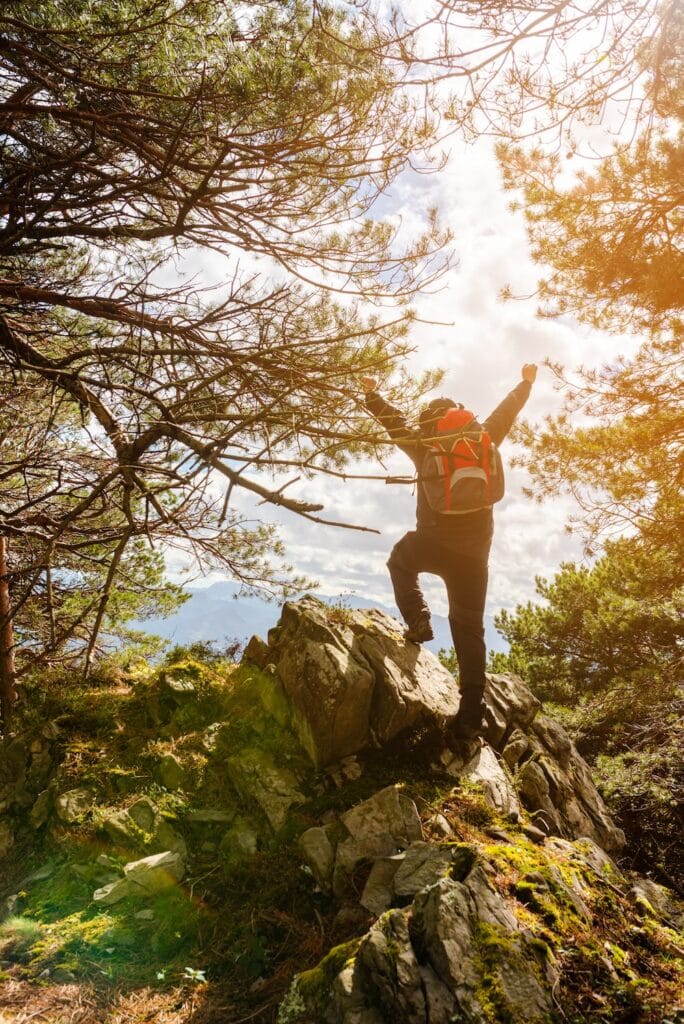 Retreat attendee at top of mountain.