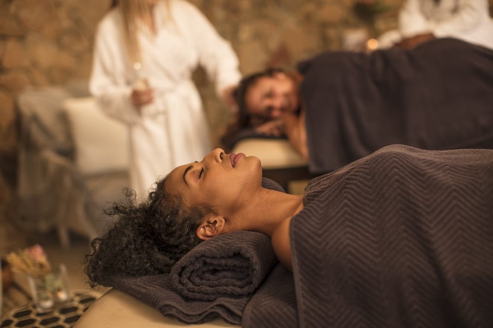 Two executives laying down for massage therapy at executive burnout retreat and residential mental health treatment center.