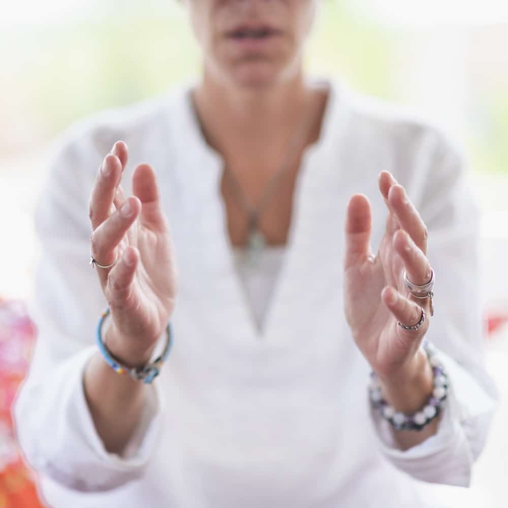 Mindful woman performing respect gesture with her hands