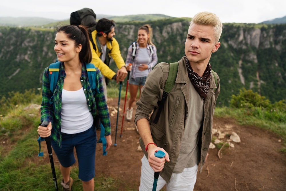 Group of happy hiker friends hiking together.