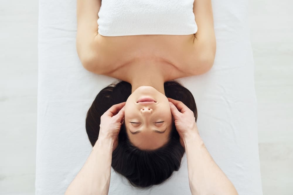 Young woman is lying down for a massage.