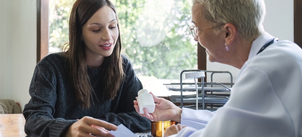 Psychiatrist helping patient understand her medication