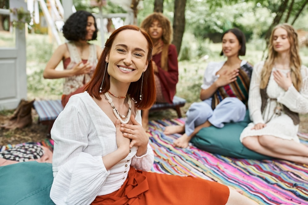 redhead woman sitting near friends at retreat