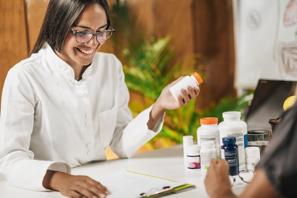 Female practitioner recommending dietary supplement to a client