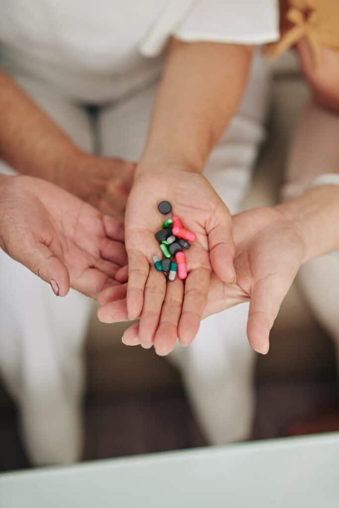 Hands holding various medications