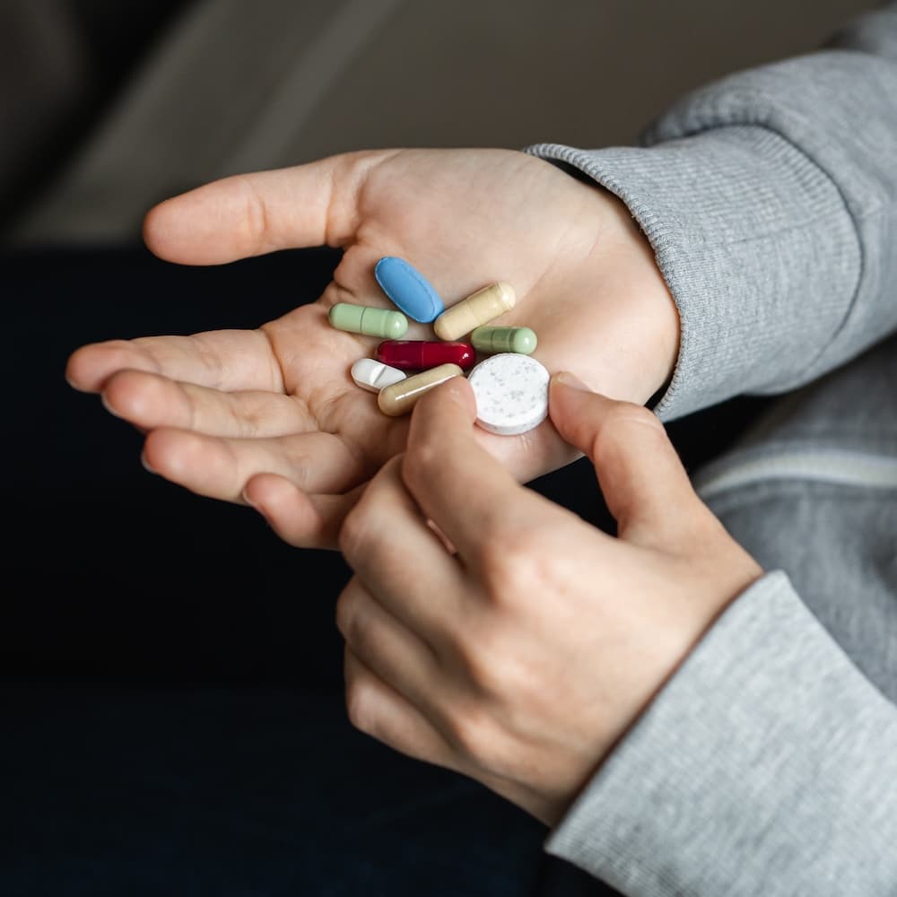 Medical pills in the hands of a person