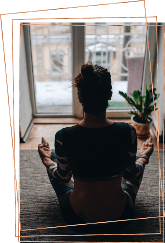 Woman sitting in lotus pose indoors