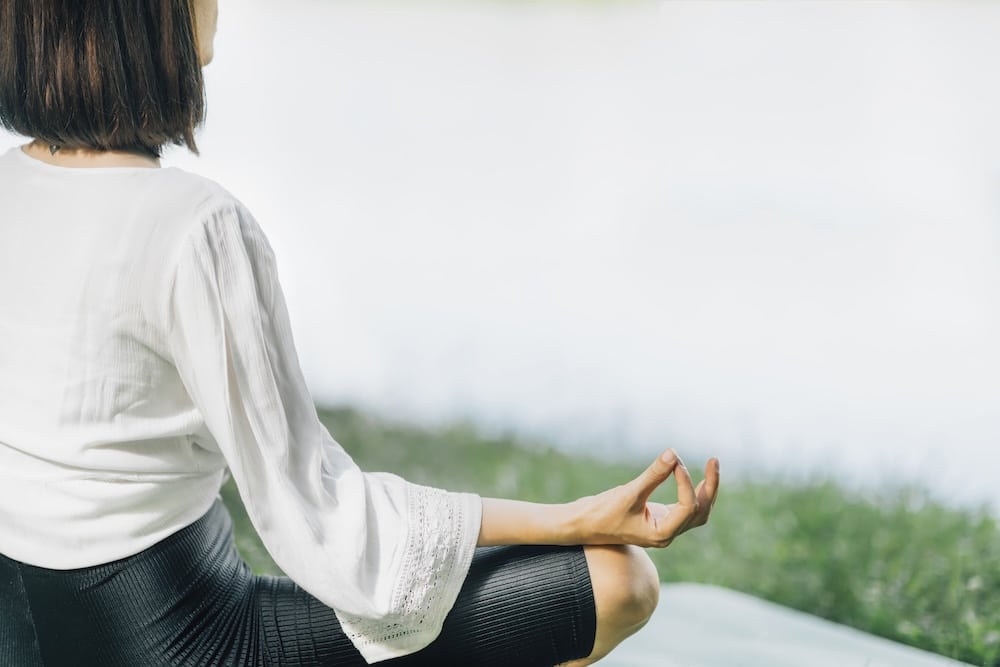 Young woman sitting in lotus position