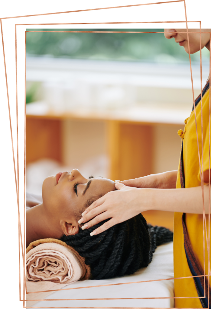 Woman lying on her back getting head massage