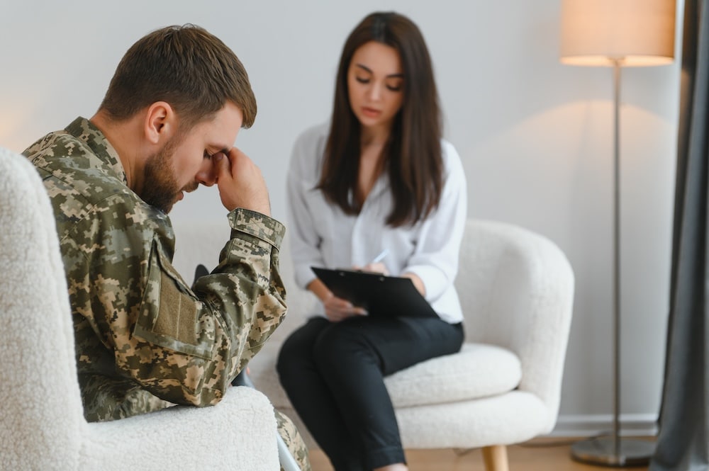 Man in therapy with psychologist for support with PTSD