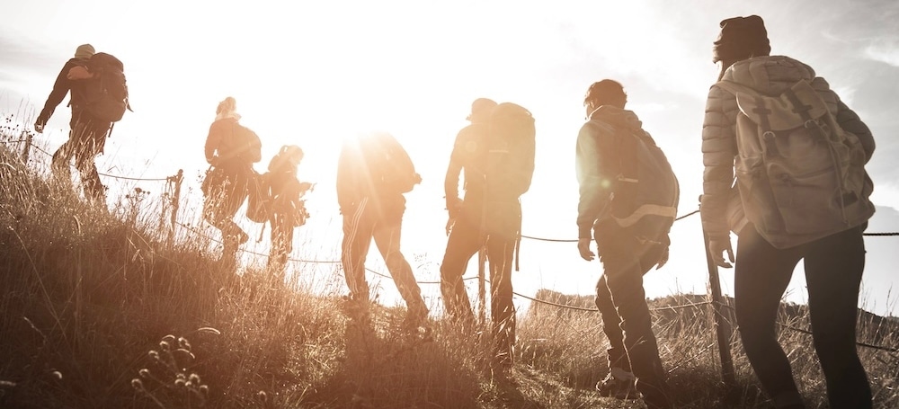 Group of hikers climbing a hill 