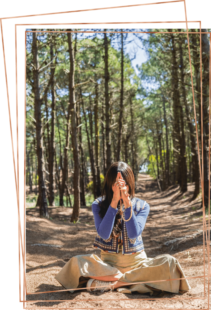 Woman meditating in the forest.