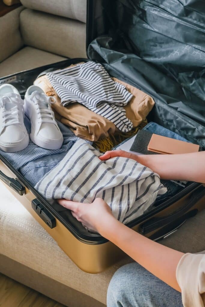 Woman packing a suitcase for travel