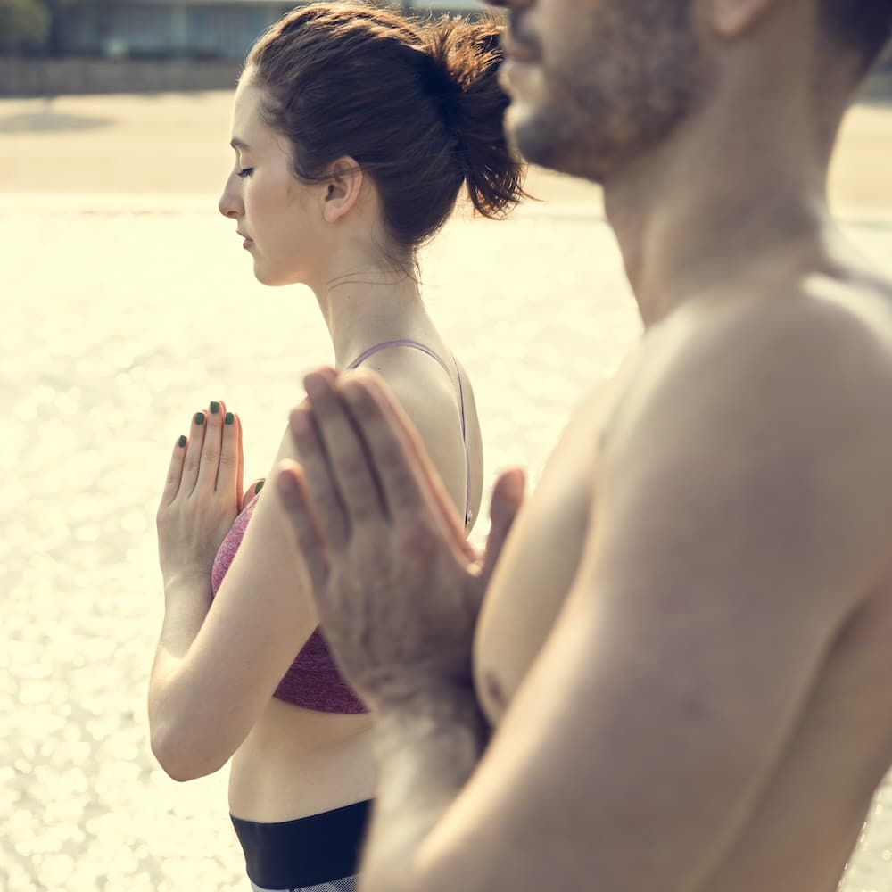 Two individuals meditating together