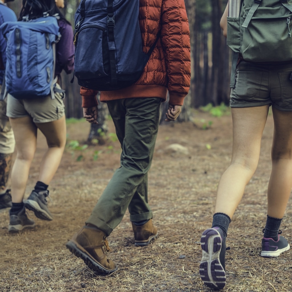 Friends walking together outdoors during recovery program.