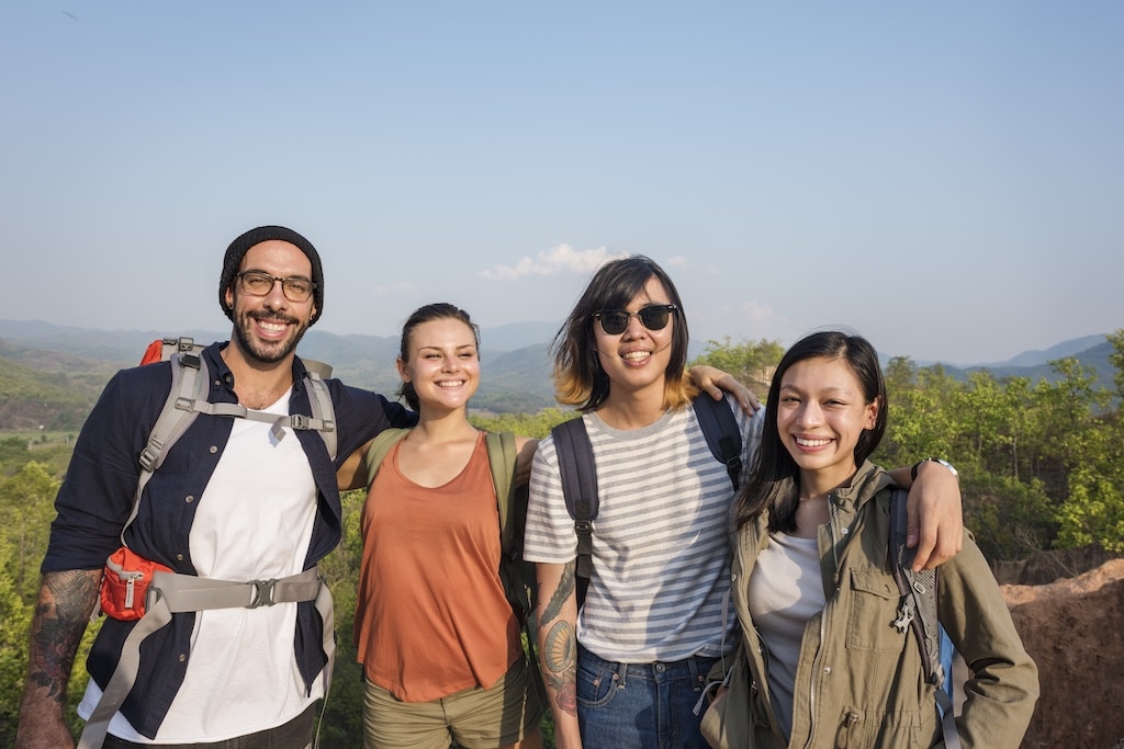 Group of people standing together while hiking.