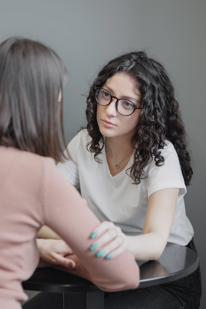 Therapist comforting client.