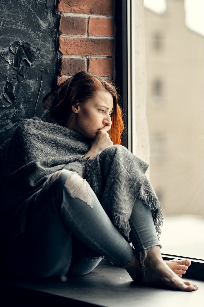 Young woman gazing out the window.