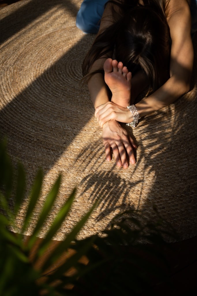 Young woman doing yoga on the floor.