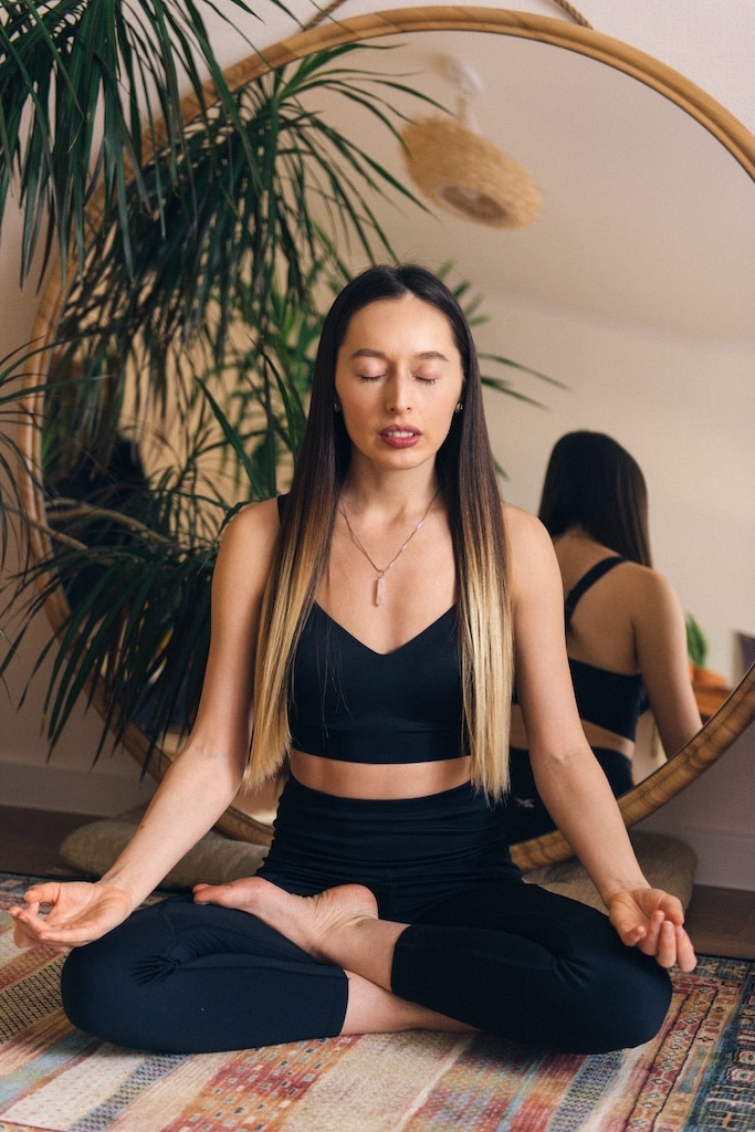 Woman sitting in lotus pose.